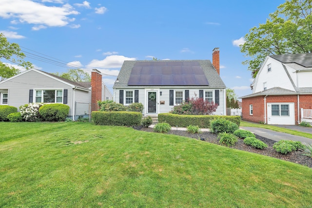 239 Bellevue Ave, West Haven, CT 06516 - view of front of property with roof mounted solar panels, a front yard, and a chimney