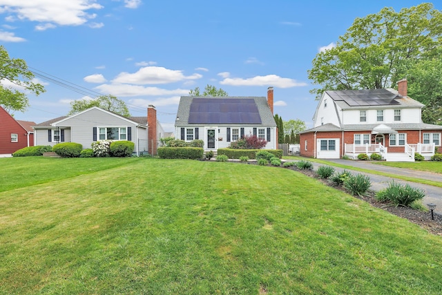 239 Bellevue Ave, West Haven, CT 06516 - dutch colonial featuring a chimney, roof mounted solar panels, and a front lawn