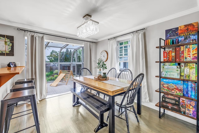 239 Bellevue Ave, West Haven, CT 06516 - dining space with crown molding, healthy amount of natural light, wood finished floors, and a chandelier