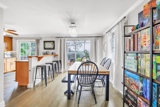 239 Bellevue Ave, West Haven, CT 06516 - dining area featuring ornamental molding, light wood-style flooring, baseboards, and a chandelier