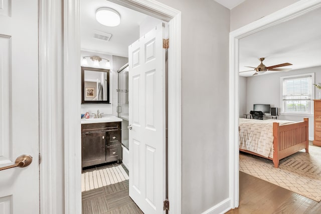 239 Bellevue Ave, West Haven, CT 06516 - corridor featuring a sink and wood finished floors