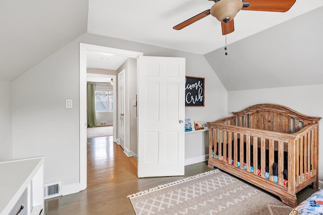 239 Bellevue Ave, West Haven, CT 06516 - bedroom featuring lofted ceiling, wood finished floors, a nursery area, a ceiling fan, and baseboards