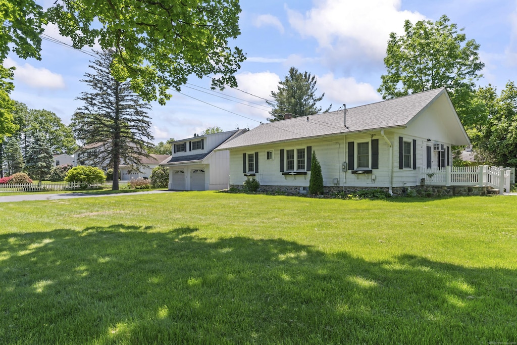 18 Glover Ave, Newtown, CT 06470 - view of front facade featuring driveway, a front lawn, and a shingled roof
