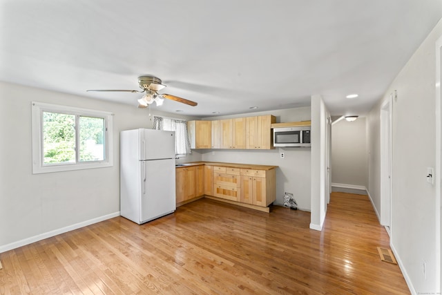 18 Glover Ave, Newtown, CT 06470 - kitchen featuring freestanding refrigerator, light brown cabinets, stainless steel microwave, light wood-style flooring, and a ceiling fan