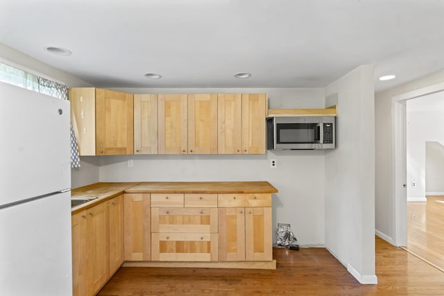 18 Glover Ave, Newtown, CT 06470 - kitchen with freestanding refrigerator, stainless steel microwave, light brown cabinets, and recessed lighting