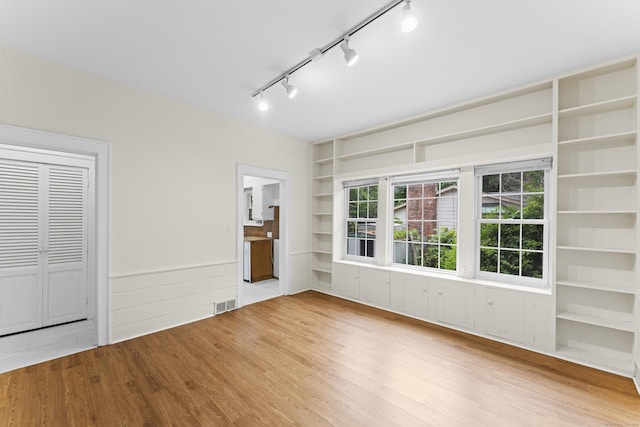 18 Glover Ave, Newtown, CT 06470 - spare room featuring wood finished floors, built in shelves, and rail lighting