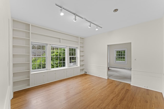 18 Glover Ave, Newtown, CT 06470 - spare room with track lighting, wood finished floors, built in features, and plenty of natural light