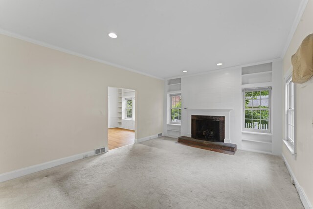 18 Glover Ave, Newtown, CT 06470 - unfurnished living room with carpet flooring, a fireplace with raised hearth, crown molding, plenty of natural light, and recessed lighting