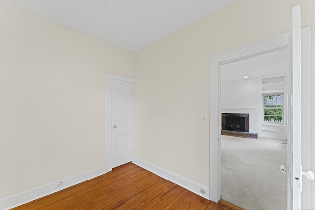 18 Glover Ave, Newtown, CT 06470 - spare room with a brick fireplace and wood finished floors
