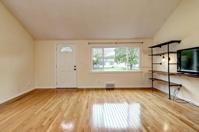 entrance foyer with wood-type flooring, lofted ceiling, and baseboards
