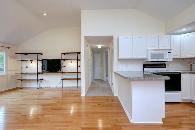 kitchen with electric range, white microwave, vaulted ceiling, white cabinets, and light wood-type flooring