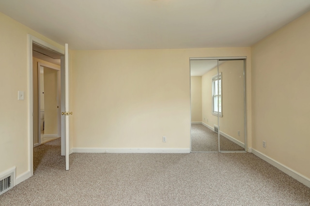 unfurnished room with carpet floors and baseboards