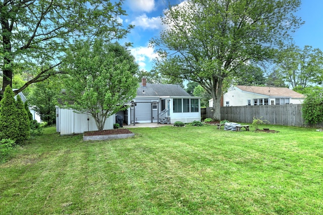 rear view of property with a sunroom and a chimney