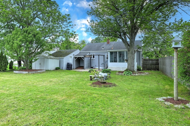 rear view of house with a sunroom, a shingled roof, and a chimney
