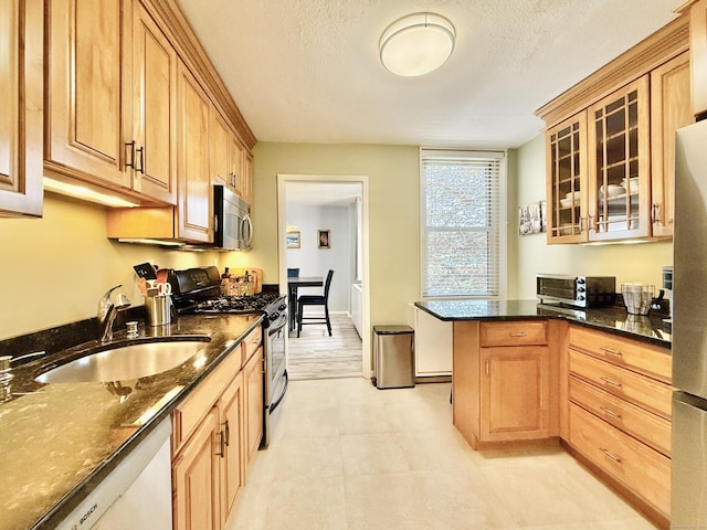 1 Strawberry Hill Ct Apt 1A, Stamford, CT 06902 - kitchen featuring stainless steel appliances, a sink, dark stone counters, and glass insert cabinets