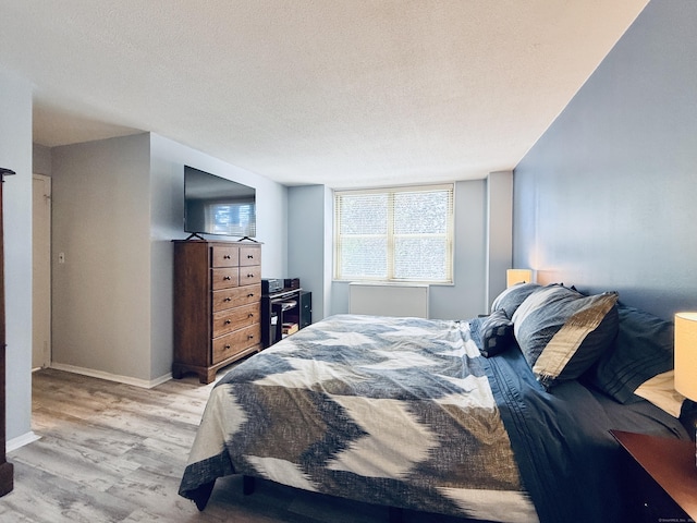 1 Strawberry Hill Ct Apt 1A, Stamford, CT 06902 - bedroom featuring wood finished floors, baseboards, and a textured ceiling