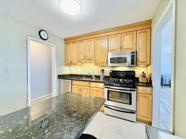1 Strawberry Hill Ct Apt 1A, Stamford, CT 06902 - kitchen with appliances with stainless steel finishes, a sink, dark stone countertops, and light brown cabinetry