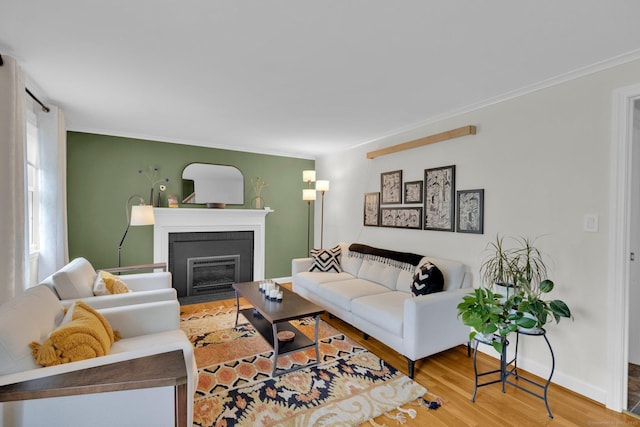 10 Knollwood Rd, Farmington, CT 06032 - living area featuring wood finished floors, a fireplace with flush hearth, ornamental molding, and baseboards