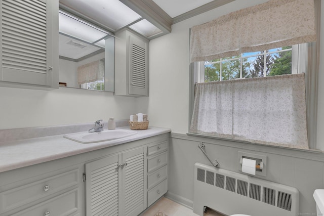 10 Knollwood Rd, Farmington, CT 06032 - bathroom with radiator, vanity, and ornamental molding