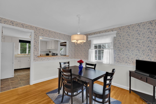 10 Knollwood Rd, Farmington, CT 06032 - dining area with wallpapered walls, a wainscoted wall, wood finished floors, and crown molding