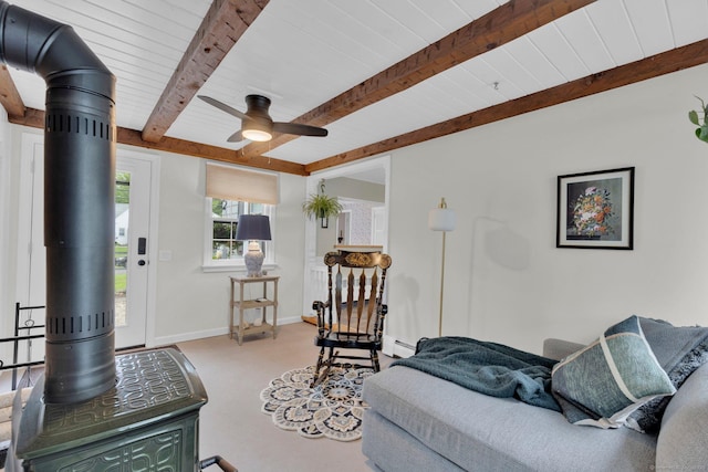 10 Knollwood Rd, Farmington, CT 06032 - carpeted living area with a wood stove, ceiling fan, a baseboard radiator, wood ceiling with exposed beams, and baseboards