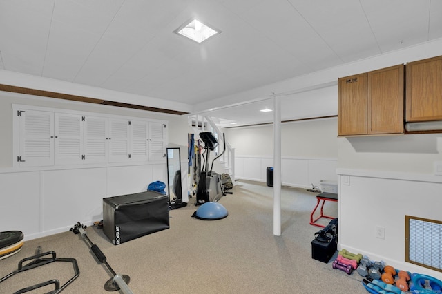 10 Knollwood Rd, Farmington, CT 06032 - workout room with carpet flooring, a decorative wall, and wainscoting