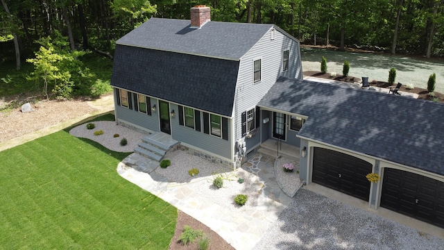 586 Essex Rd, Westbrook, CT 06498 - view of front facade featuring roof with shingles, a chimney, a front yard, and an attached garage