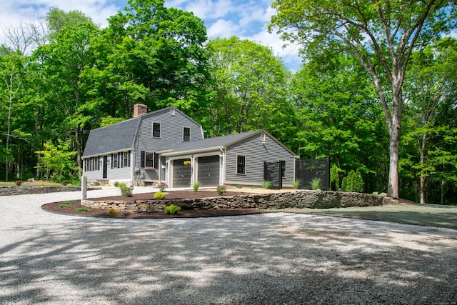 586 Essex Rd, Westbrook, CT 06498 - view of front of property featuring an attached garage, a chimney, roof with shingles, a gambrel roof, and driveway