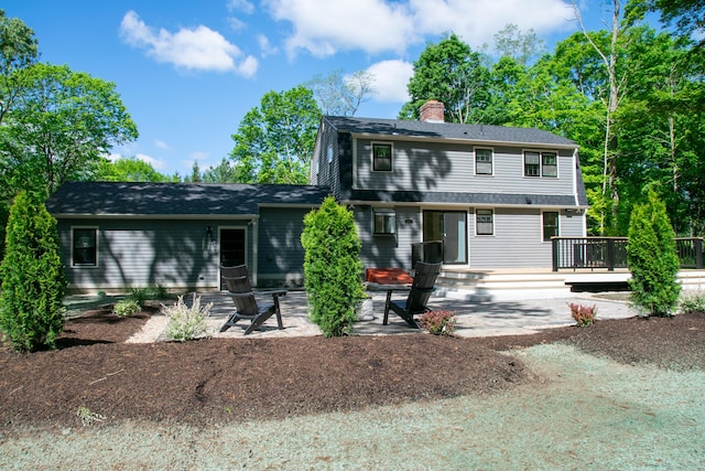 586 Essex Rd, Westbrook, CT 06498 - view of front of house featuring a chimney, a patio area, and a deck
