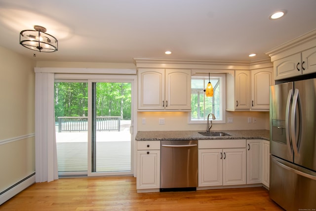 586 Essex Rd, Westbrook, CT 06498 - kitchen featuring stainless steel appliances, baseboard heating, a sink, dark stone countertops, and recessed lighting