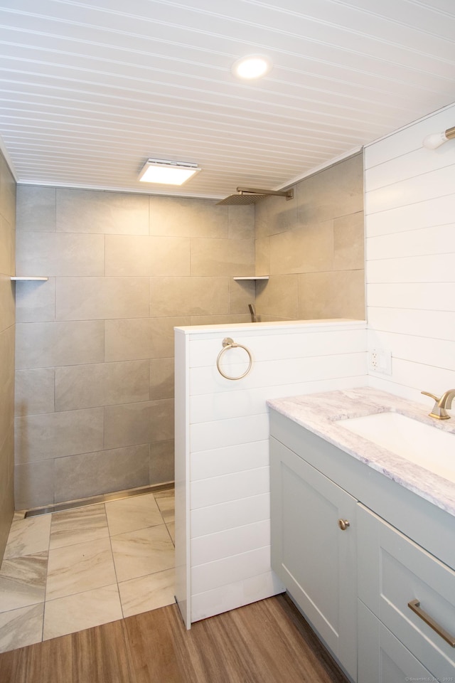 586 Essex Rd, Westbrook, CT 06498 - full bathroom with vanity, a walk in shower, recessed lighting, and tile walls