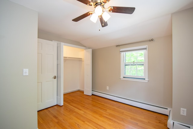 586 Essex Rd, Westbrook, CT 06498 - unfurnished bedroom with a baseboard heating unit, vaulted ceiling, light wood-style floors, a closet, and a baseboard radiator