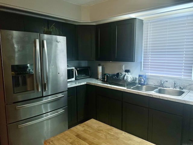 433 Garden St, Hartford, CT 06112 - kitchen with stainless steel refrigerator with ice dispenser, a sink, light countertops, and white microwave
