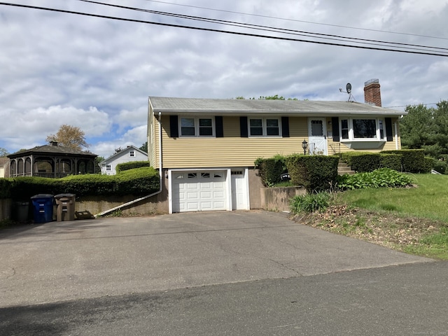 17 S Grove St, Vernon, CT 06066 - view of front of property featuring asphalt driveway, a chimney, and a garage