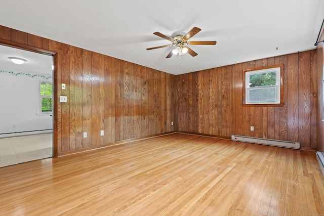 654 Beach Pond Rd, Voluntown, CT 06384 - empty room featuring baseboard heating, a ceiling fan, wood finished floors, plenty of natural light, and wood walls