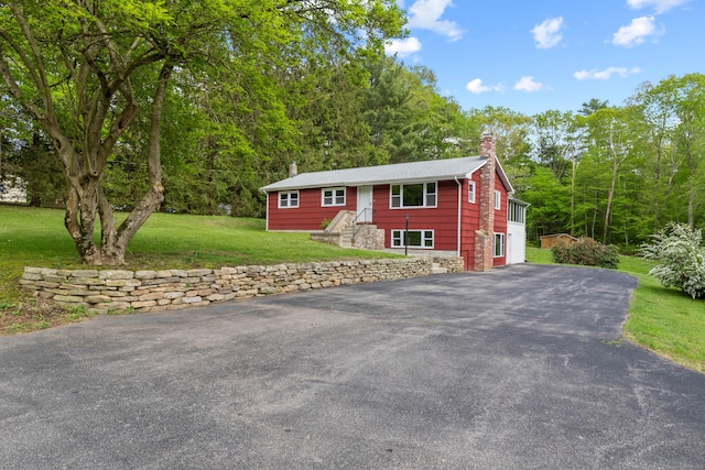 654 Beach Pond Rd, Voluntown, CT 06384 - view of front of house with asphalt driveway, a chimney, and a front yard