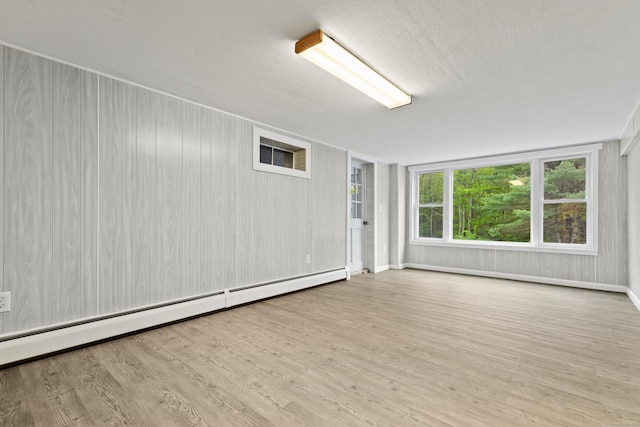 654 Beach Pond Rd, Voluntown, CT 06384 - spare room with a baseboard heating unit, wood finished floors, and baseboards
