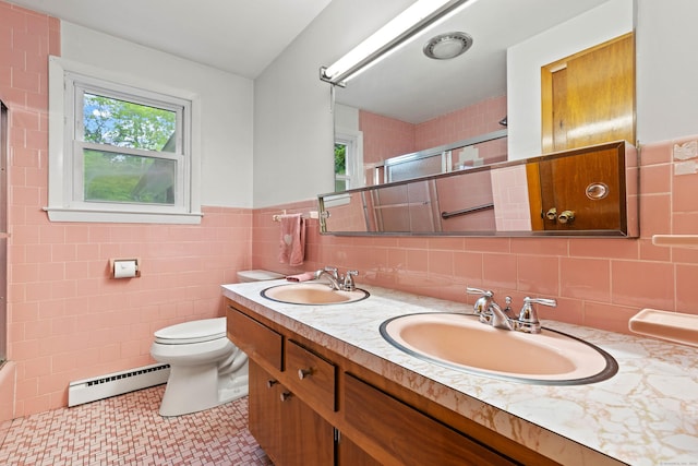 654 Beach Pond Rd, Voluntown, CT 06384 - bathroom with a baseboard heating unit, an enclosed shower, double vanity, tile walls, and toilet