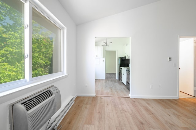 4 Farview Ave Unit 1-10, Danbury, CT 06810 - empty room with lofted ceiling, light wood-style flooring, a wall mounted air conditioner, baseboards, and a chandelier