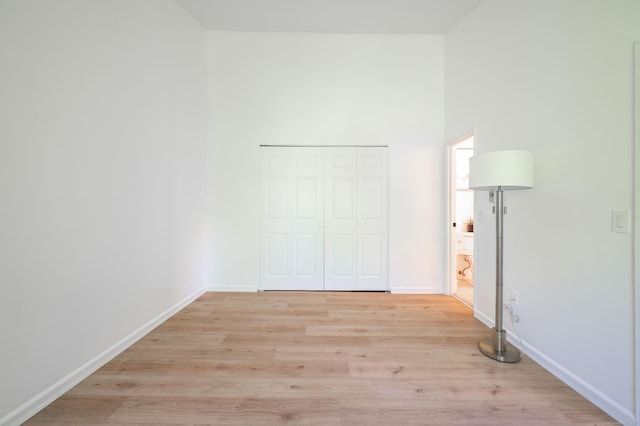 4 Farview Ave Unit 1-10, Danbury, CT 06810 - unfurnished bedroom featuring light wood-type flooring, a closet, baseboards, and a high ceiling