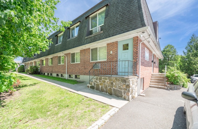 4 Farview Ave Unit 1-10, Danbury, CT 06810 - view of front facade featuring roof with shingles, brick siding, mansard roof, and a front lawn