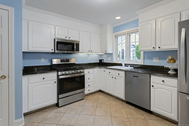 44 Village Ct Unit 44, Wilton, CT 06897 - kitchen with appliances with stainless steel finishes, a sink, ornamental molding, white cabinets, and light tile patterned floors