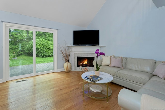 44 Village Ct Unit 44, Wilton, CT 06897 - living area featuring vaulted ceiling, wood finished floors, a premium fireplace, and baseboards
