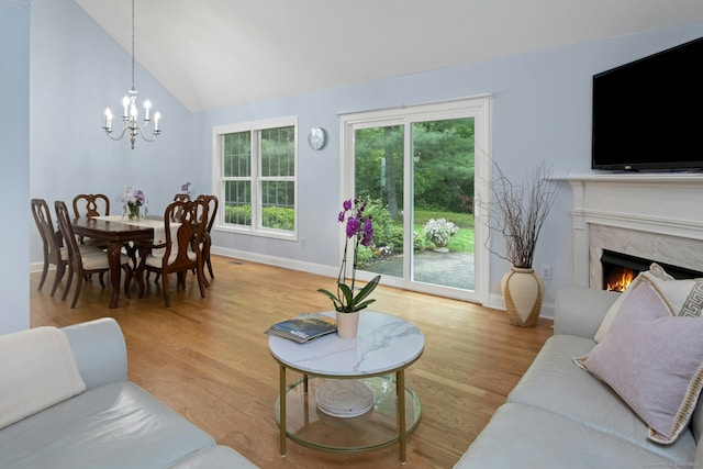 44 Village Ct Unit 44, Wilton, CT 06897 - living area featuring baseboards, lofted ceiling, a chandelier, and wood finished floors