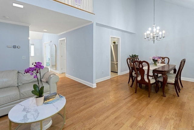 44 Village Ct Unit 44, Wilton, CT 06897 - dining room featuring a chandelier, baseboards, light wood-style floors, and crown molding