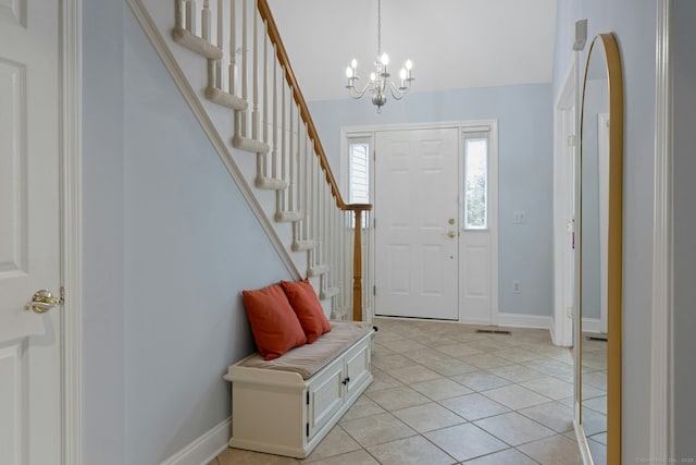 44 Village Ct Unit 44, Wilton, CT 06897 - foyer with a chandelier, light tile patterned flooring, stairway, and baseboards
