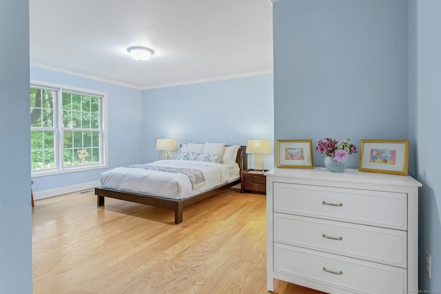 44 Village Ct Unit 44, Wilton, CT 06897 - bedroom with crown molding, light wood-style flooring, and baseboards
