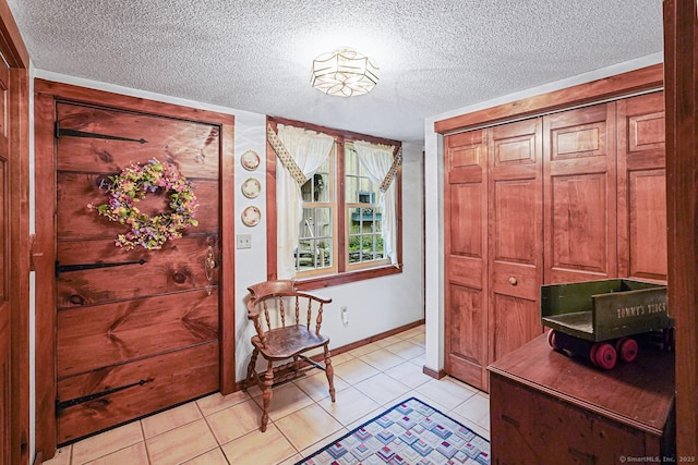 9 Pheasant Ln, Brooklyn, CT 06234 - foyer entrance featuring a textured ceiling, baseboards, and light tile patterned floors