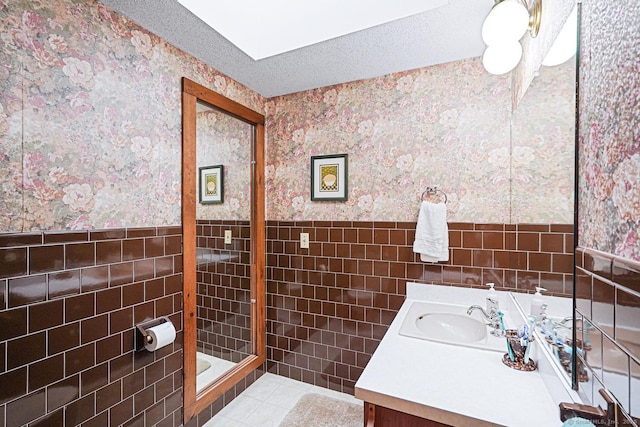 9 Pheasant Ln, Brooklyn, CT 06234 - full bathroom with wallpapered walls, a wainscoted wall, tile walls, vanity, and a stall shower