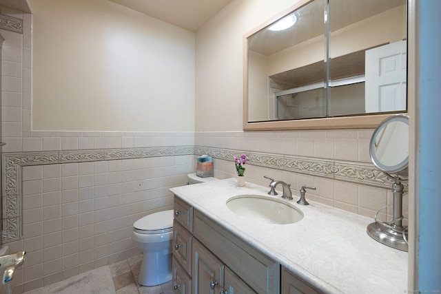 9 Meadowbrook Rd, New Fairfield, CT 06812 - bathroom with toilet, vanity, an enclosed shower, wainscoting, and tile walls